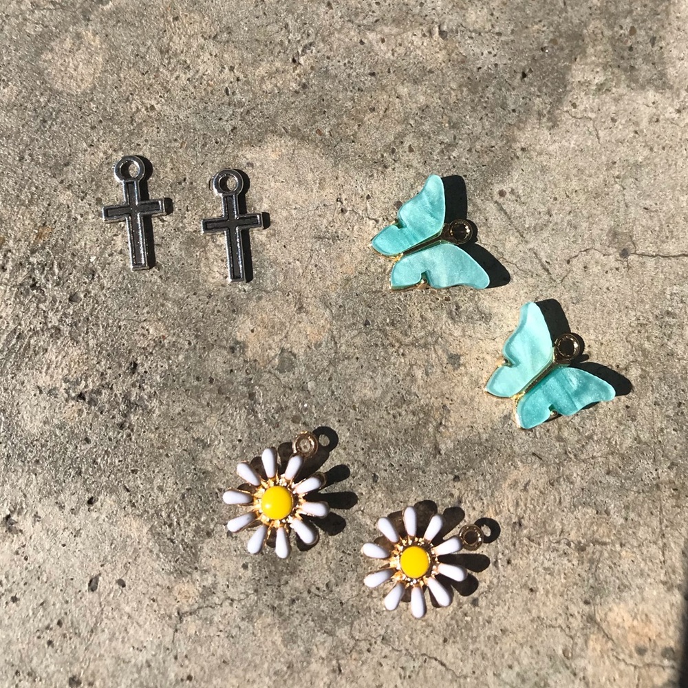 Blue butterfly, yellow daisy, and cross earrings